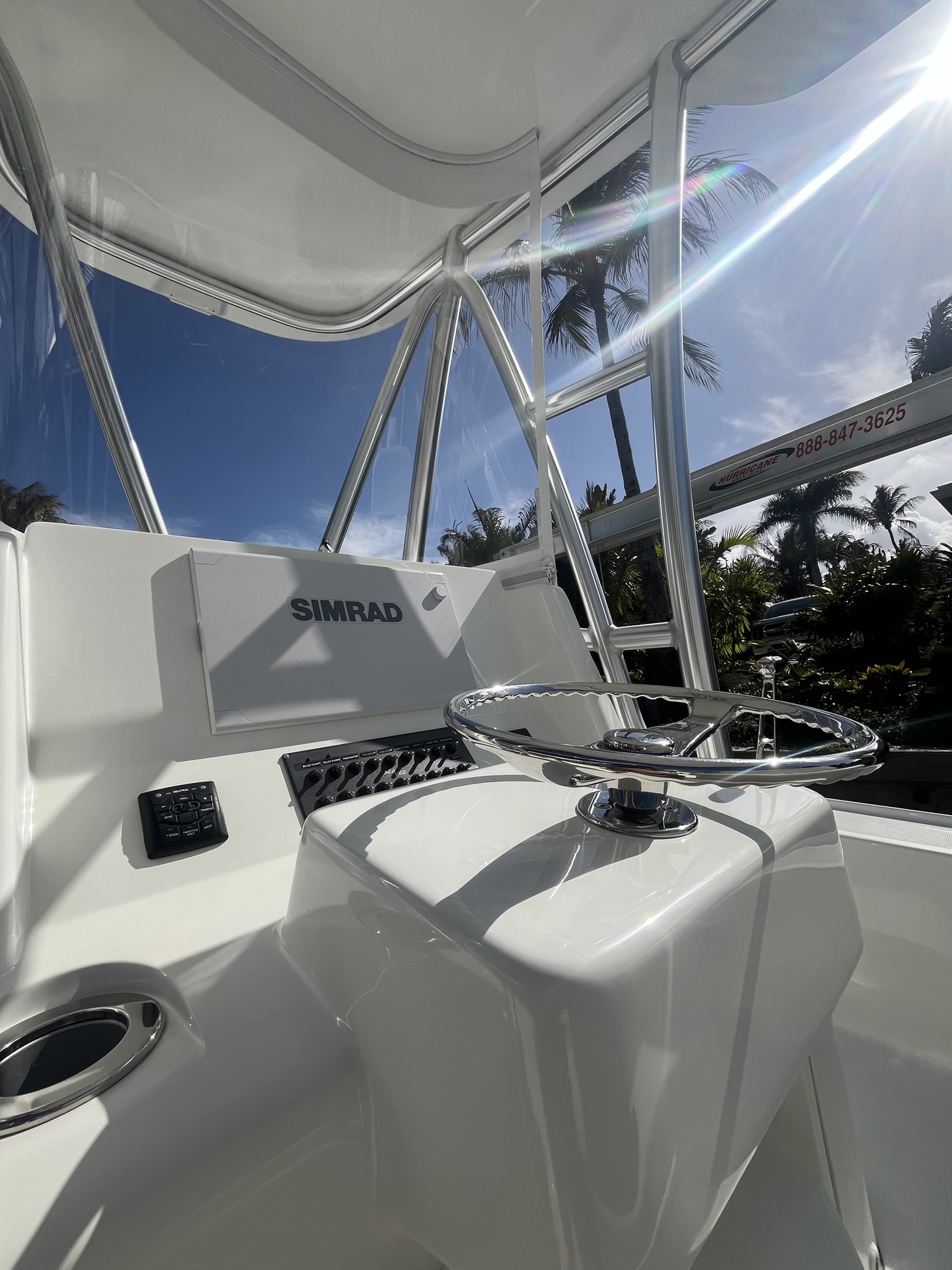 Clean boat helm with polished stainless catching the light